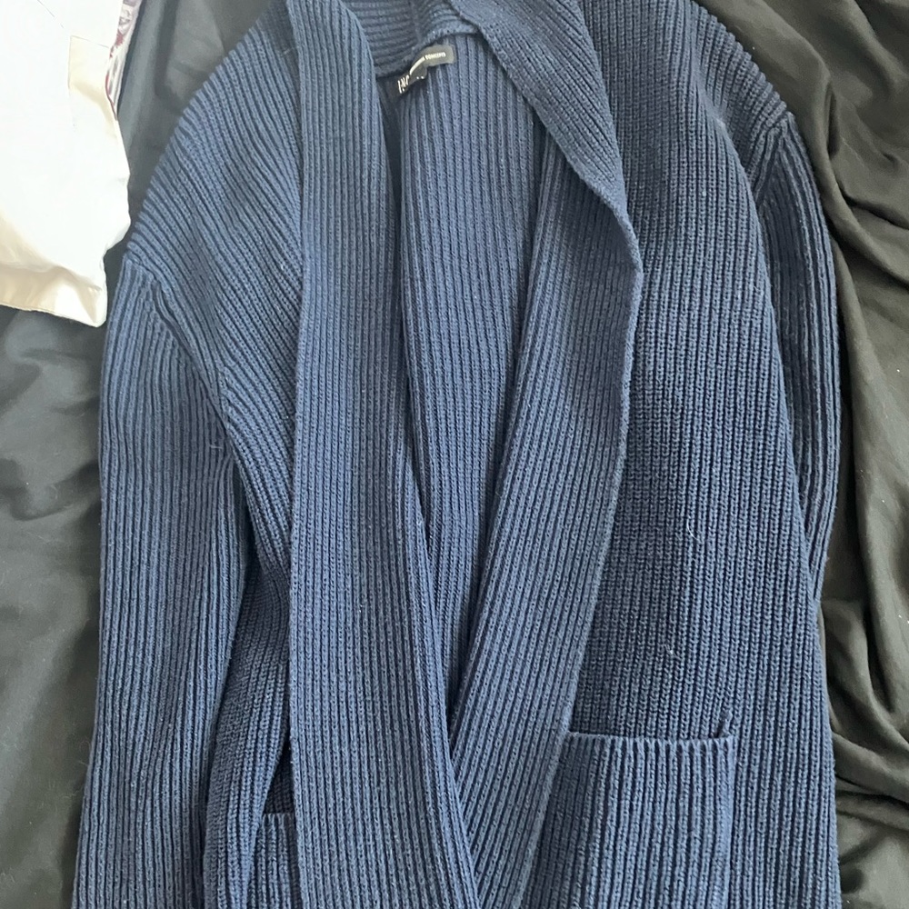 This sweater is navy blue, rough material, made of cotton